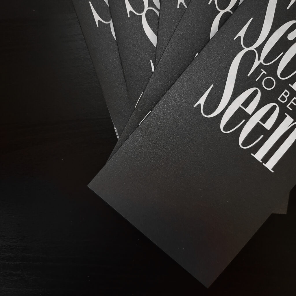 Black metallic paper with white ink